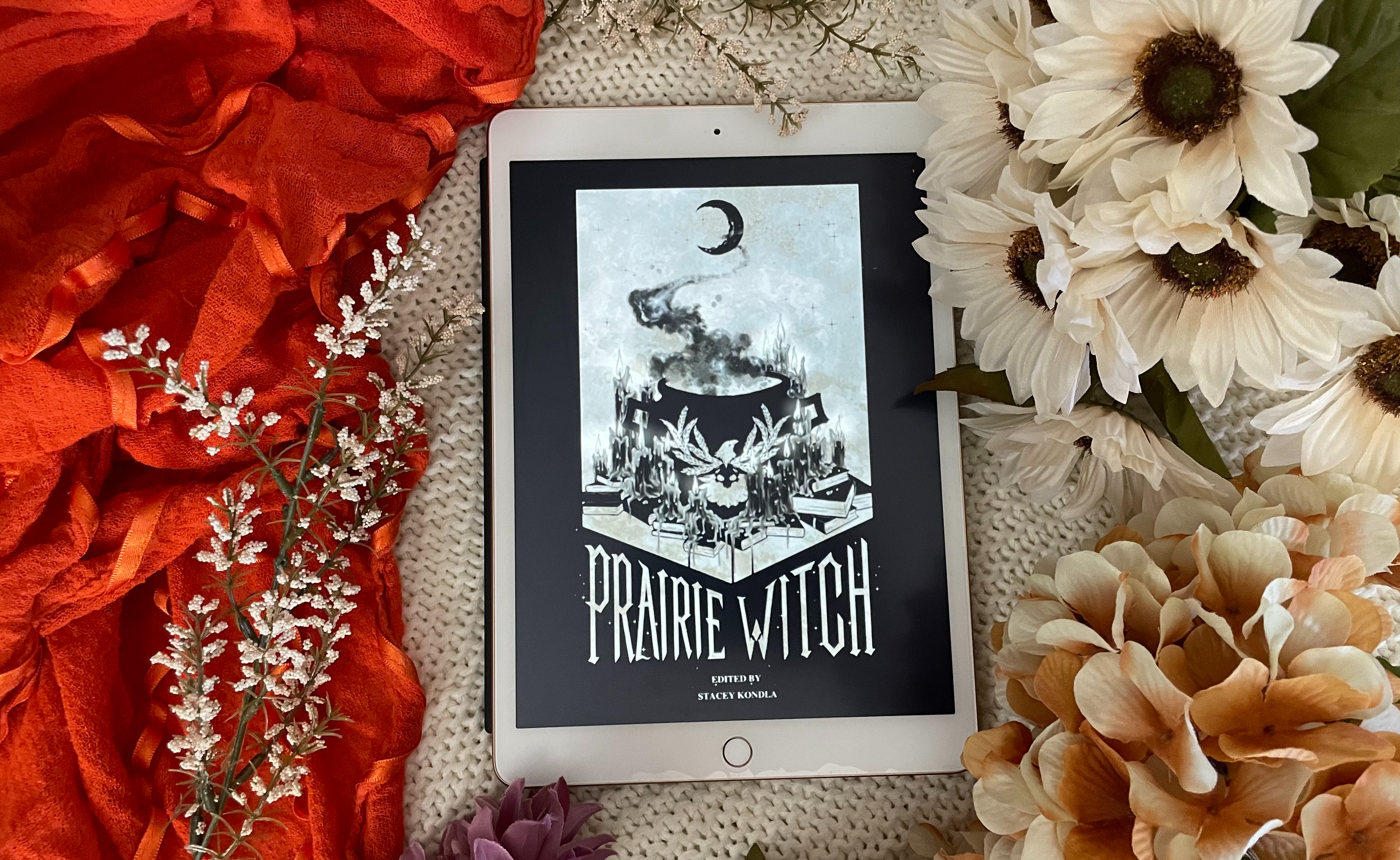Book Prairie Witch on background of fall flowers